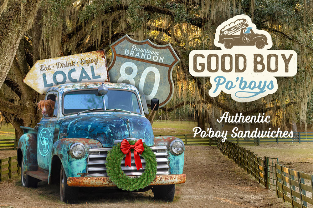 Good Boy Po'boys logo. Antique truck with dog leaning out passenger window, parked in front of trees with Spanish moss. Road signs reading: Eat, Drink Enjoy. Local. Downtown Brandon. 80. Additional Text: Good Boy Po'boys. Authentic Po'boy Sandwiches.